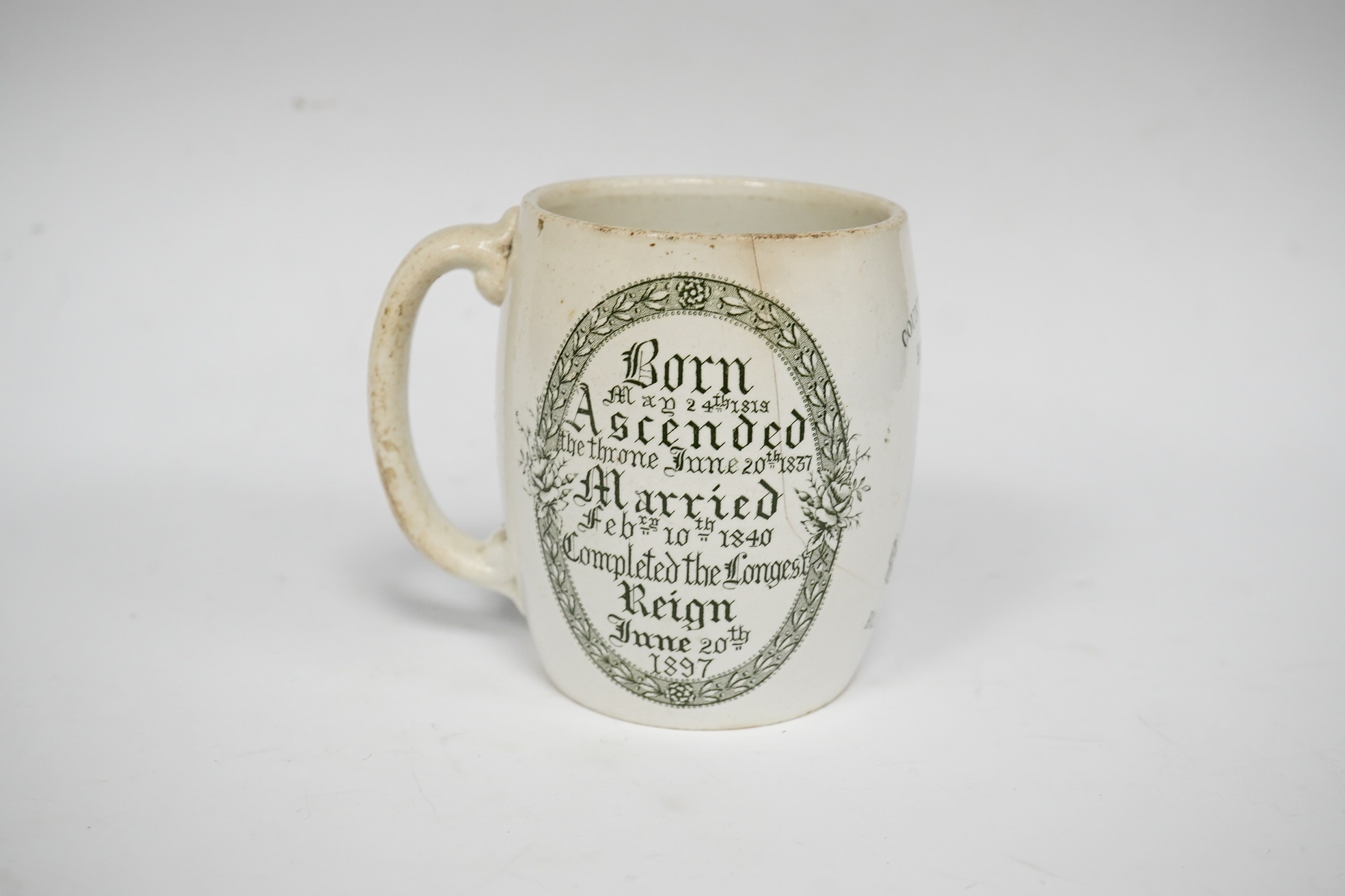 A Queen Victoria commemorative mug celebrating the 1897 Diamond Jubilee, County Borough of Brighton, 10cm high. Condition - poor
